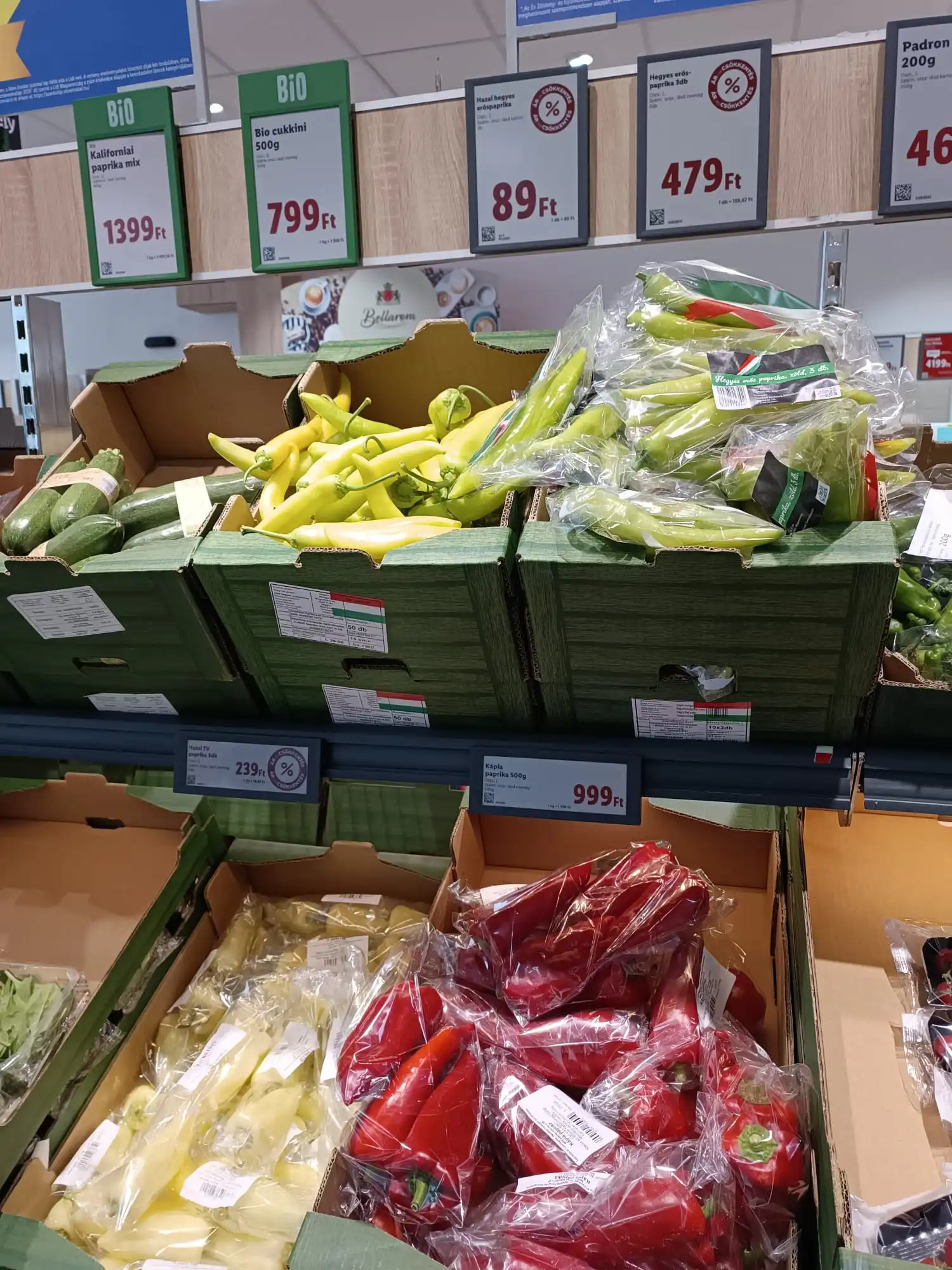 Yellow, green and red peppers displayed in a Hungarian supermarket with prices shown in Hungarian Forint (Ft).